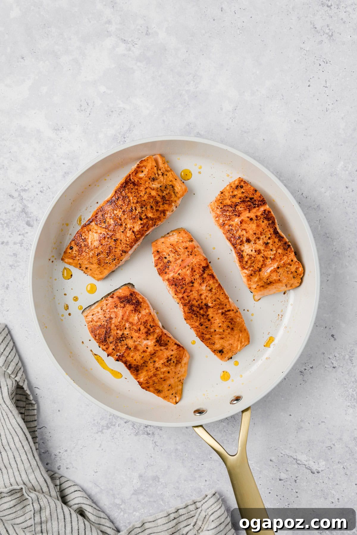 Engagement Salmon 7 Salmon fillets seasoned in a skillet before searing for Marry Me Salmon