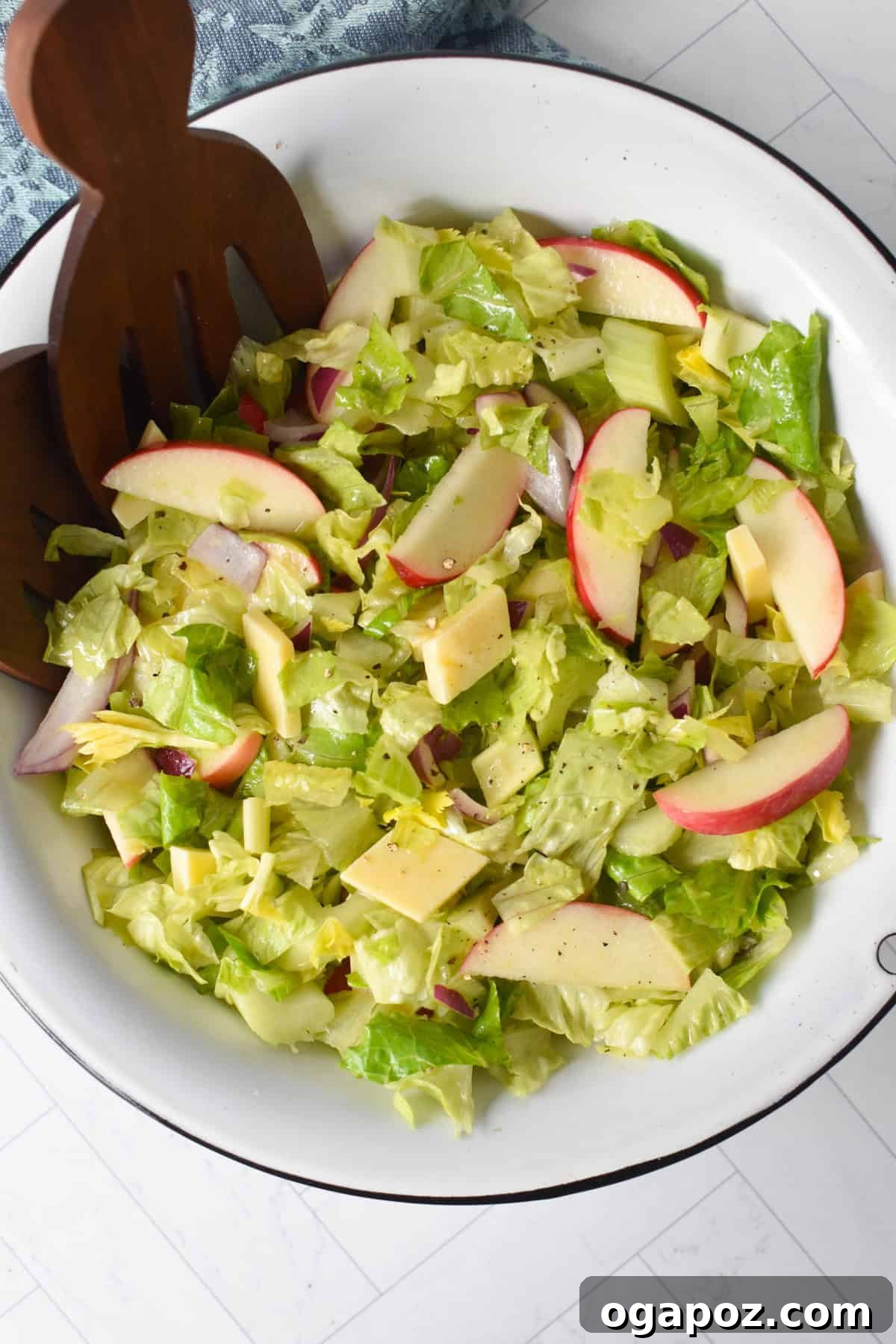 Refreshing Apple Celery Crunch 2 Apple and Celery Salad in a white bowl with wooden serving spoons