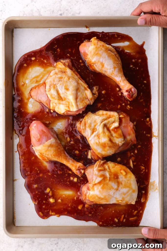 Fall-Off-The-Bone Baked BBQ Chicken Legs 5 Step 2: Coating chicken legs in the homemade BBQ sauce.