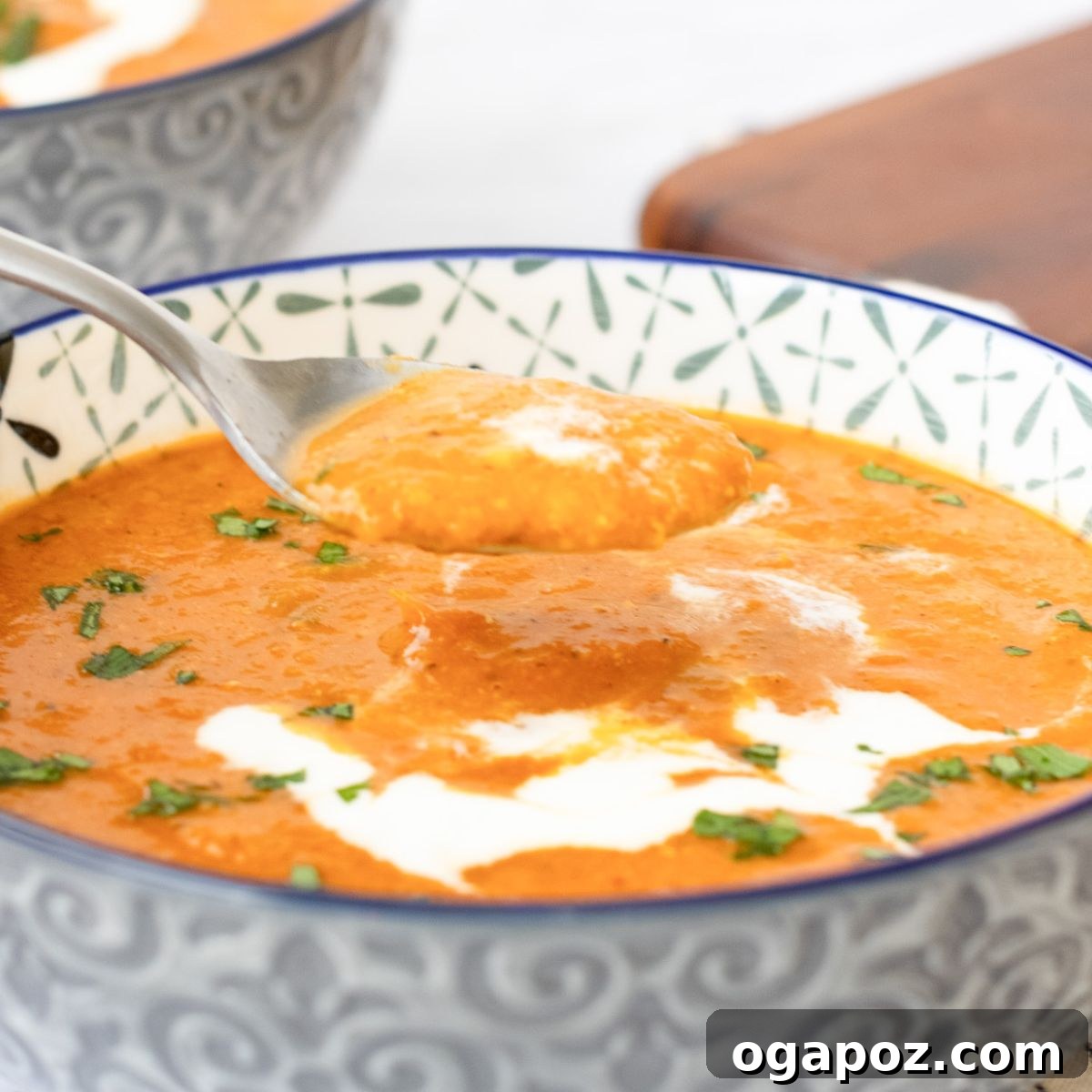The Ultimate List: 20 Must-Try Lentil Soups 11 Comforting Lentil Tomato Soup with a spoon in a bowl