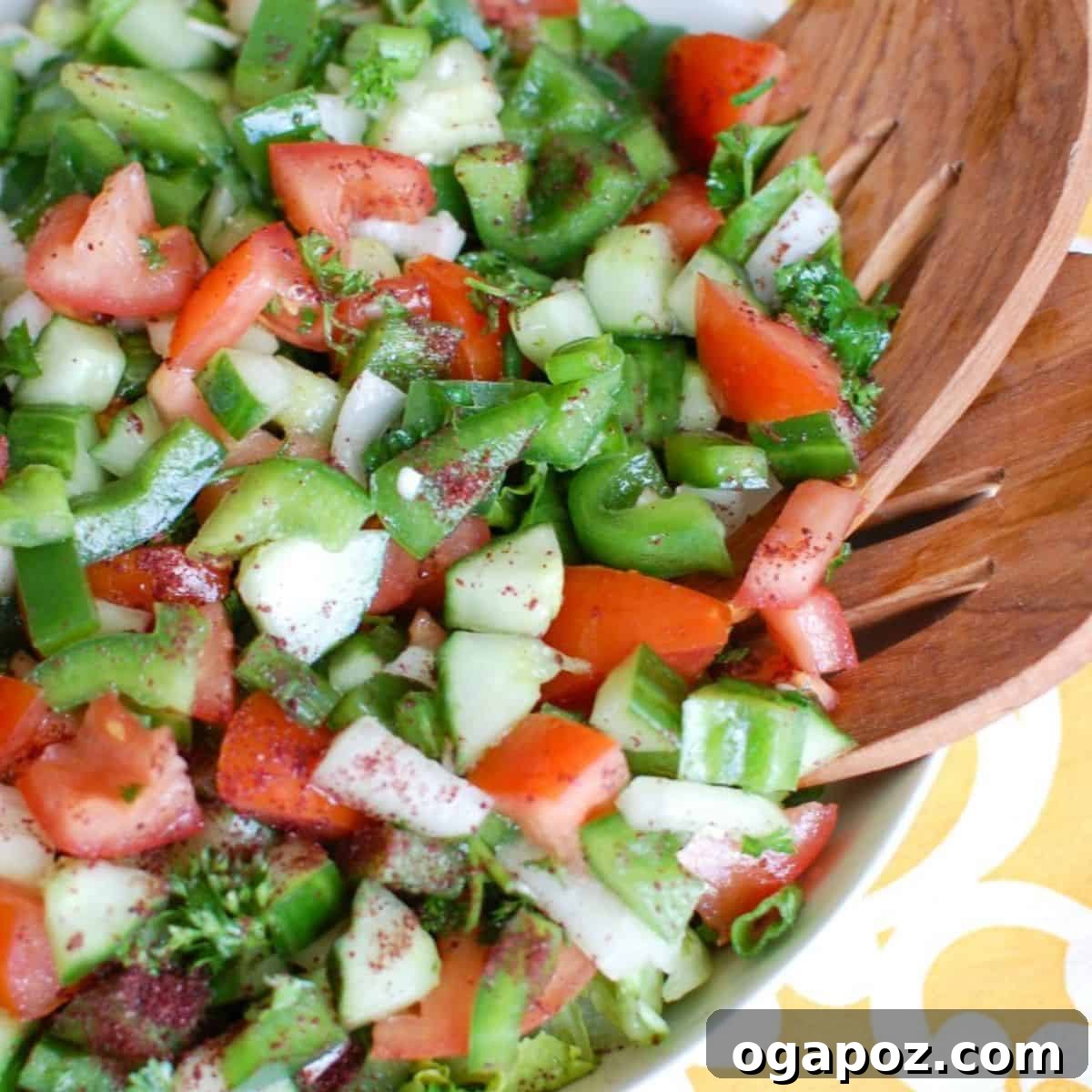 Fresh Easy Lebanese Salad in a white bowl with wooden serving spoons