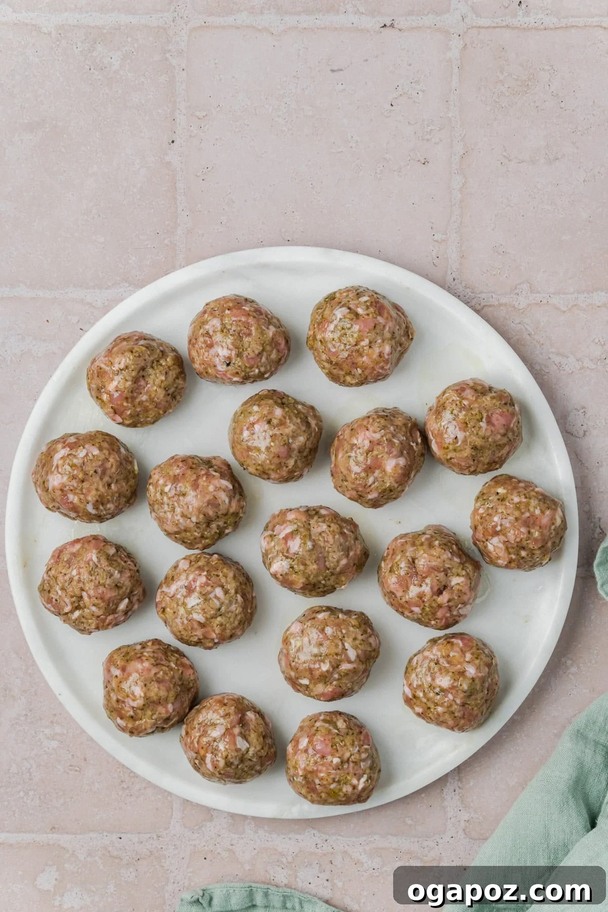 Emerald Pesto Turkey Bites 7 Uniformly rolled Pesto Turkey Meatballs arranged on a clean plate, showing their consistent shape before cooking.