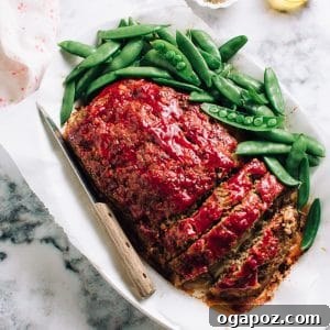The Meatloaf Recipe That Turns Haters Into Fanatics 10 The best meatloaf, sliced on a plate with snap peas.