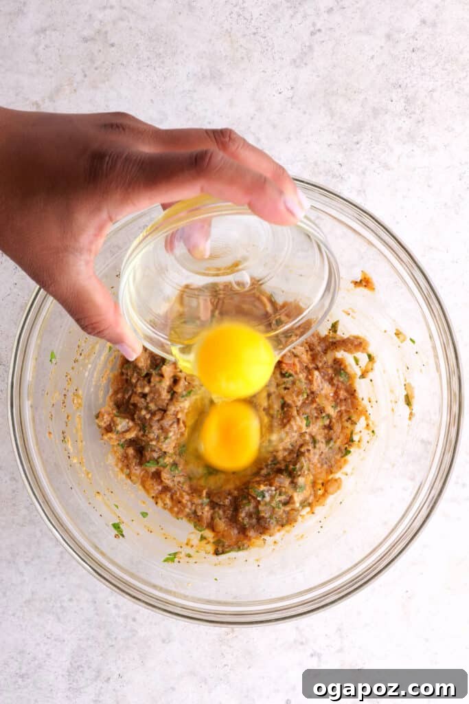 The Meatloaf Recipe That Turns Haters Into Fanatics 6 adding the egg to the meatloaf mixture