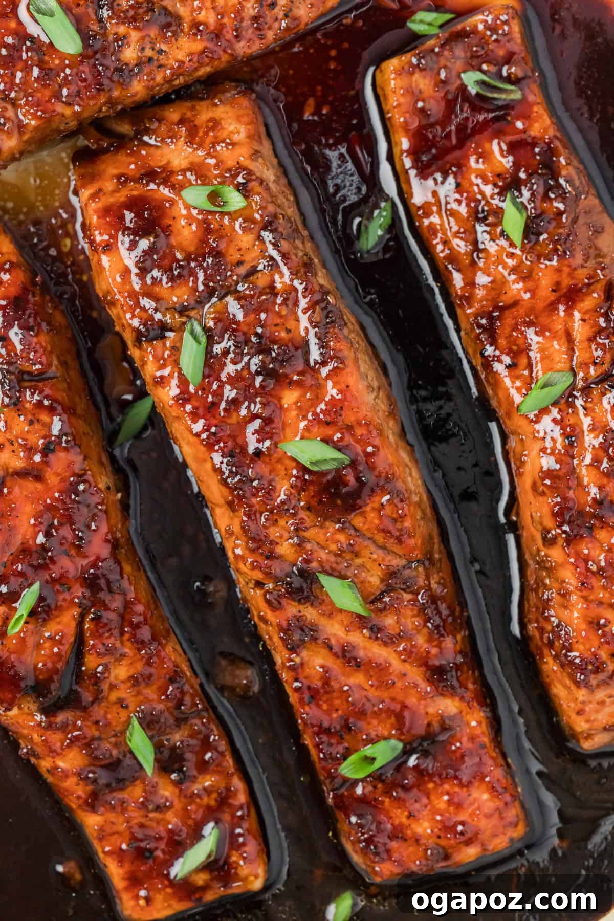Sticky Bourbon Salmon 7 A perfectly cooked Bourbon Glazed Salmon fillet shimmering with glaze, presented attractively on a white plate, ready for serving.