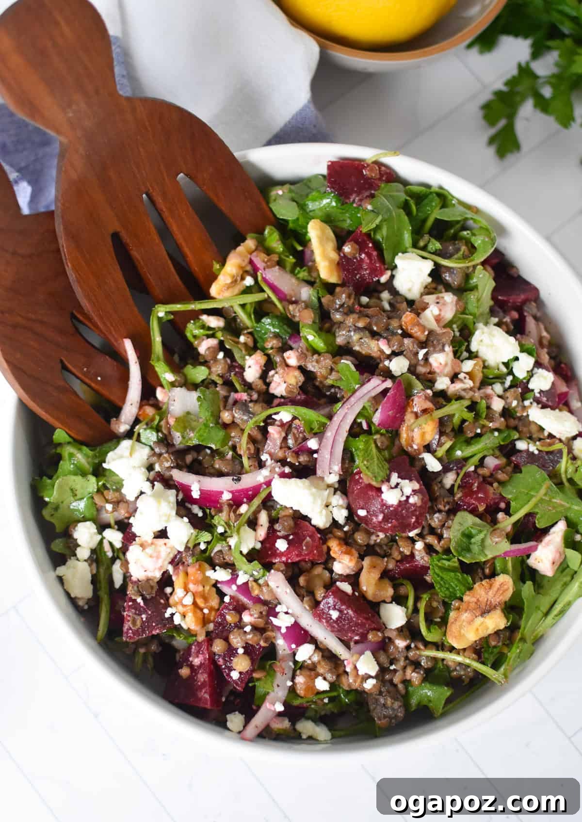 Vibrant Lentil and Beet Salad 2 Lentil Beet Salad with two wooden spoons, showing a vibrant mix of lentils, beets, feta, and herbs.