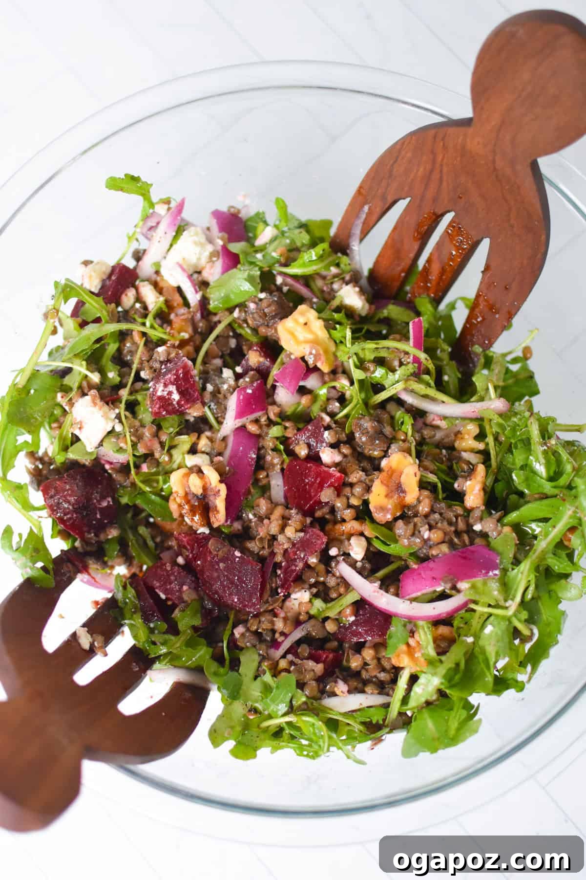 Vibrant Lentil and Beet Salad 9 Mediterranean Lentil Beet Salad with Feta and Walnuts in a clean bowl, with wooden serving spoons.