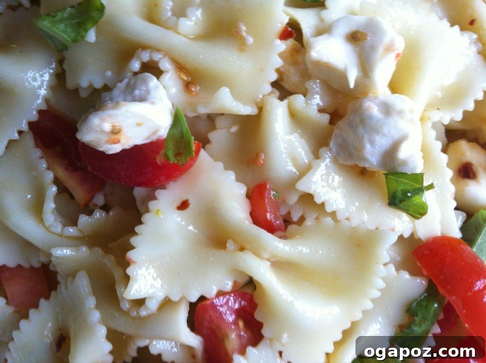 Close-up of Caprese Pasta Salad, highlighting fresh ingredients and dressing