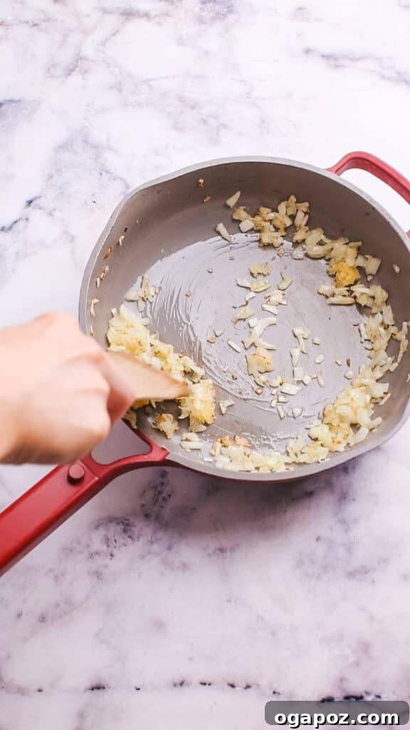Sautéing onions and garlic in a large skillet, releasing fragrant aromas