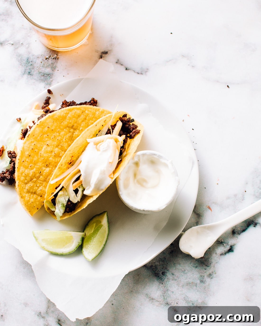 A vibrant close-up of Ultimate Beef Tacos garnished with fresh toppings and a sprinkle of cilantro