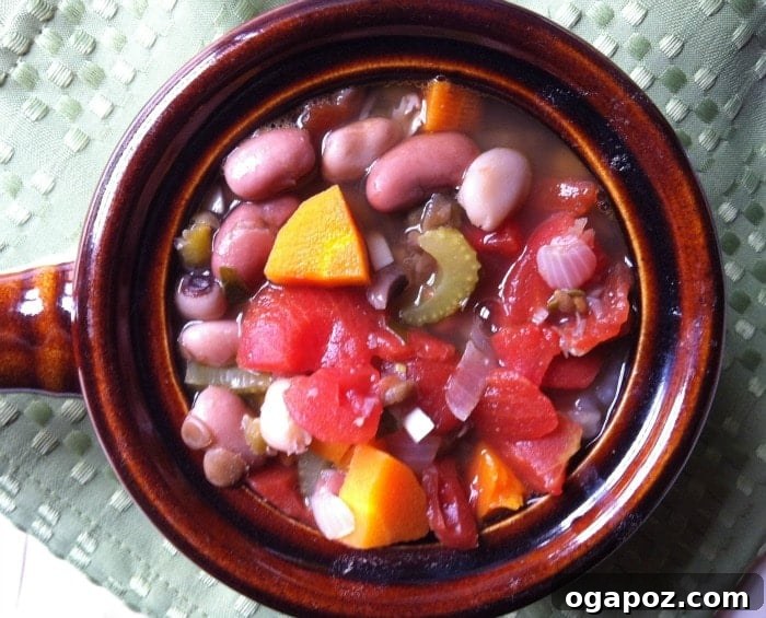 Mom's Hearty 15-Bean Soup 2 Delicious bowl of 15 bean soup, garnished with fresh herbs and a swirl of cream, ready to be enjoyed as a comforting meal.