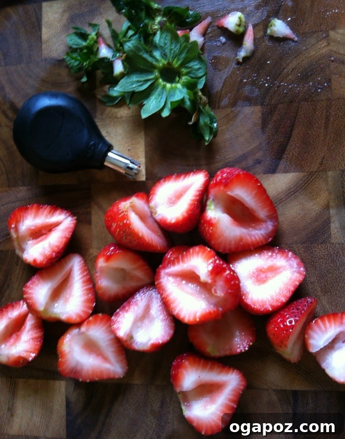 Refreshing Fruit Medley with Zesty Honey-Yogurt Dressing 5 Perfectly sliced strawberries arranged on a cutting board, demonstrating how easily they can be prepared for a fruit salad or garnish.