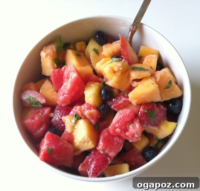 Refreshing Fruit Medley with Zesty Honey-Yogurt Dressing 10 A large, inviting bowl filled with a colorful array of chopped fruits, beautifully tossed with the creamy yogurt honey lemon dressing, ready to serve.
