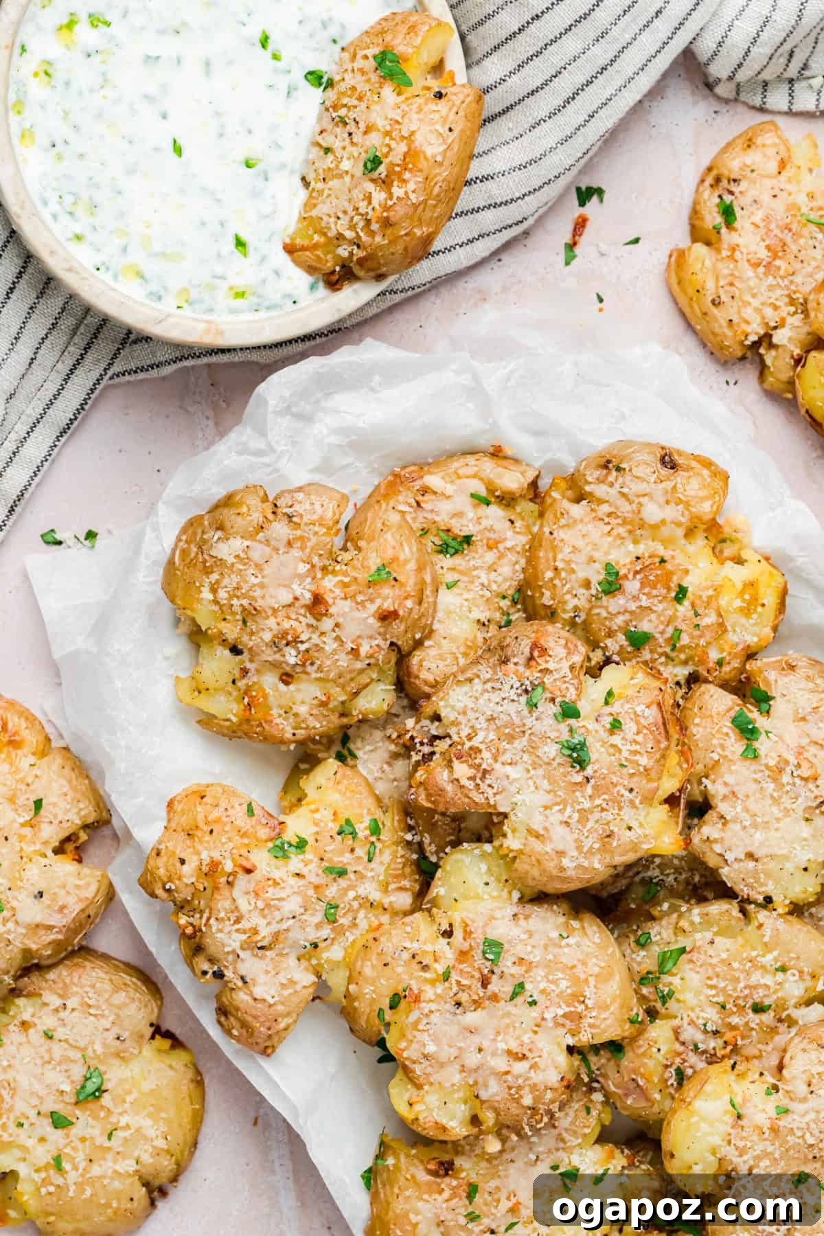 Crispy Garlic Parmesan Smashed Potatoes 7 Oven-baked garlic smashed potatoes garnished with fresh herbs, ready to serve.