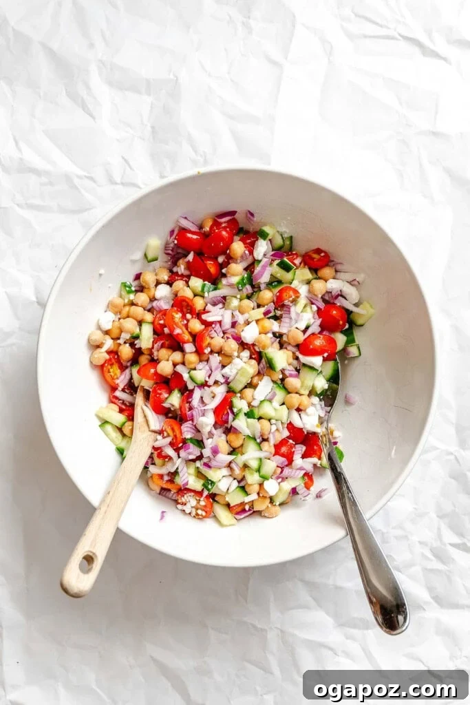 Bright Summer Orzo Salad 7 A large mixing bowl with various chopped vegetables, feta cheese, and chickpeas, ready for the orzo.