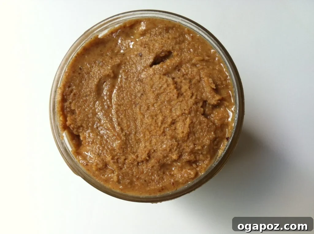 Easy Homemade Almond Butter 3 Glass jar filled with smooth homemade almond butter, ready to be enjoyed