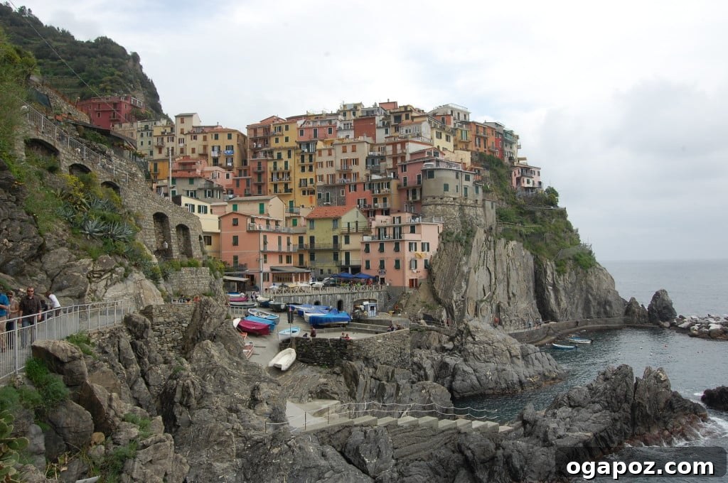 Italy's Coastal Charms: Cinque Terre and Santa Margherita 10 Breathtaking coastal panorama showing terraced vineyards and a quaint village in Cinque Terre