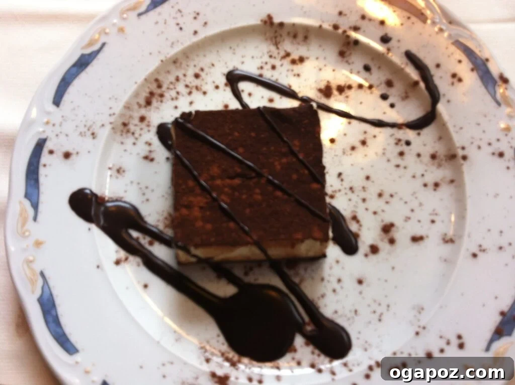 Italy's Coastal Charms: Cinque Terre and Santa Margherita 6 Decadent tiramisu dessert with cocoa powder dusting on a white plate