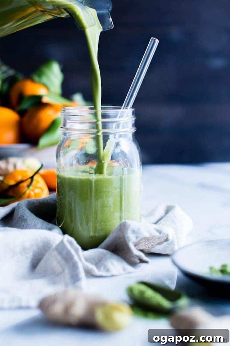 Transform Your Health: 25+ Irresistible Smoothie Creations 2 Green smoothie being poured into a blender with oranges in the background