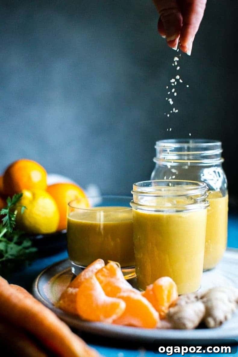 Transform Your Health: 25+ Irresistible Smoothie Creations 12 An orange being squeezed into a smoothie in a blender