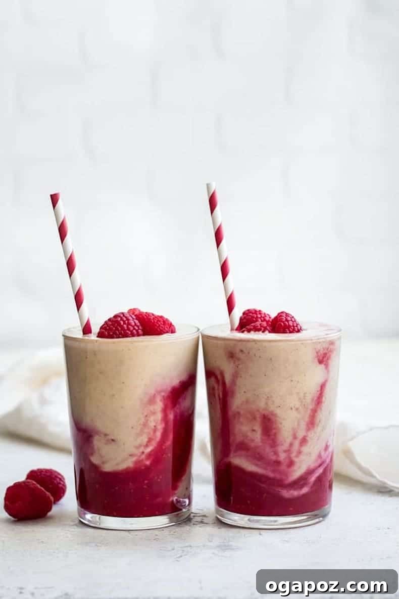 Transform Your Health: 25+ Irresistible Smoothie Creations 16 Peanut butter and jelly smoothie in a glass with a berry garnish