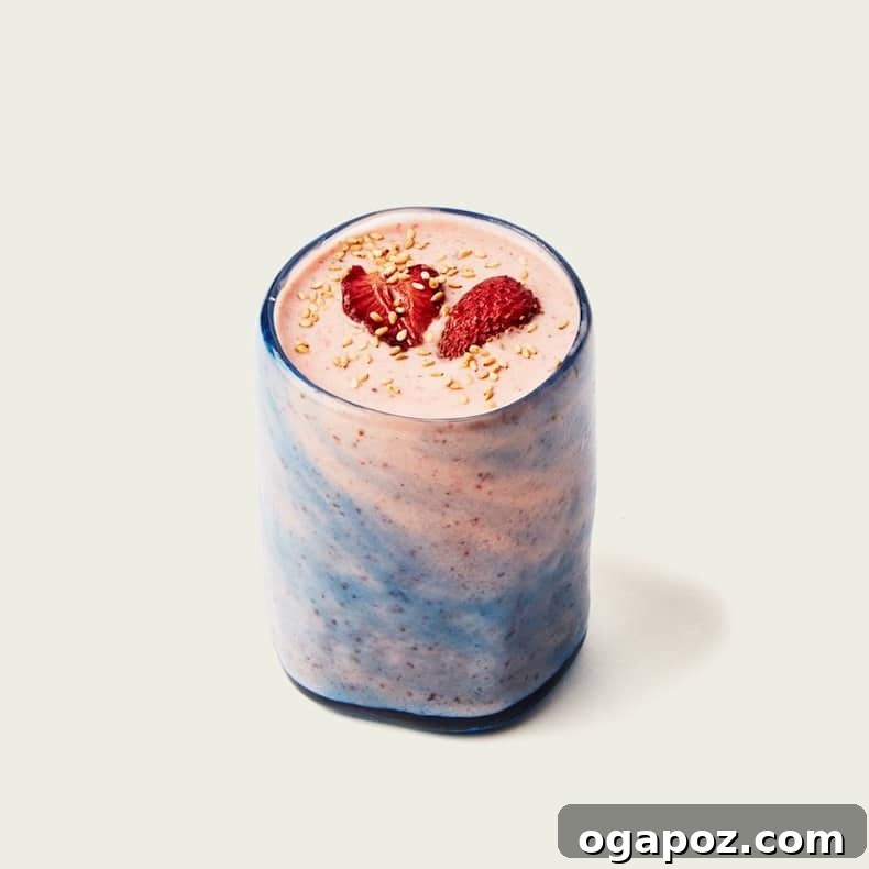Transform Your Health: 25+ Irresistible Smoothie Creations 9 Strawberry smoothie in a glass with a blue swirl