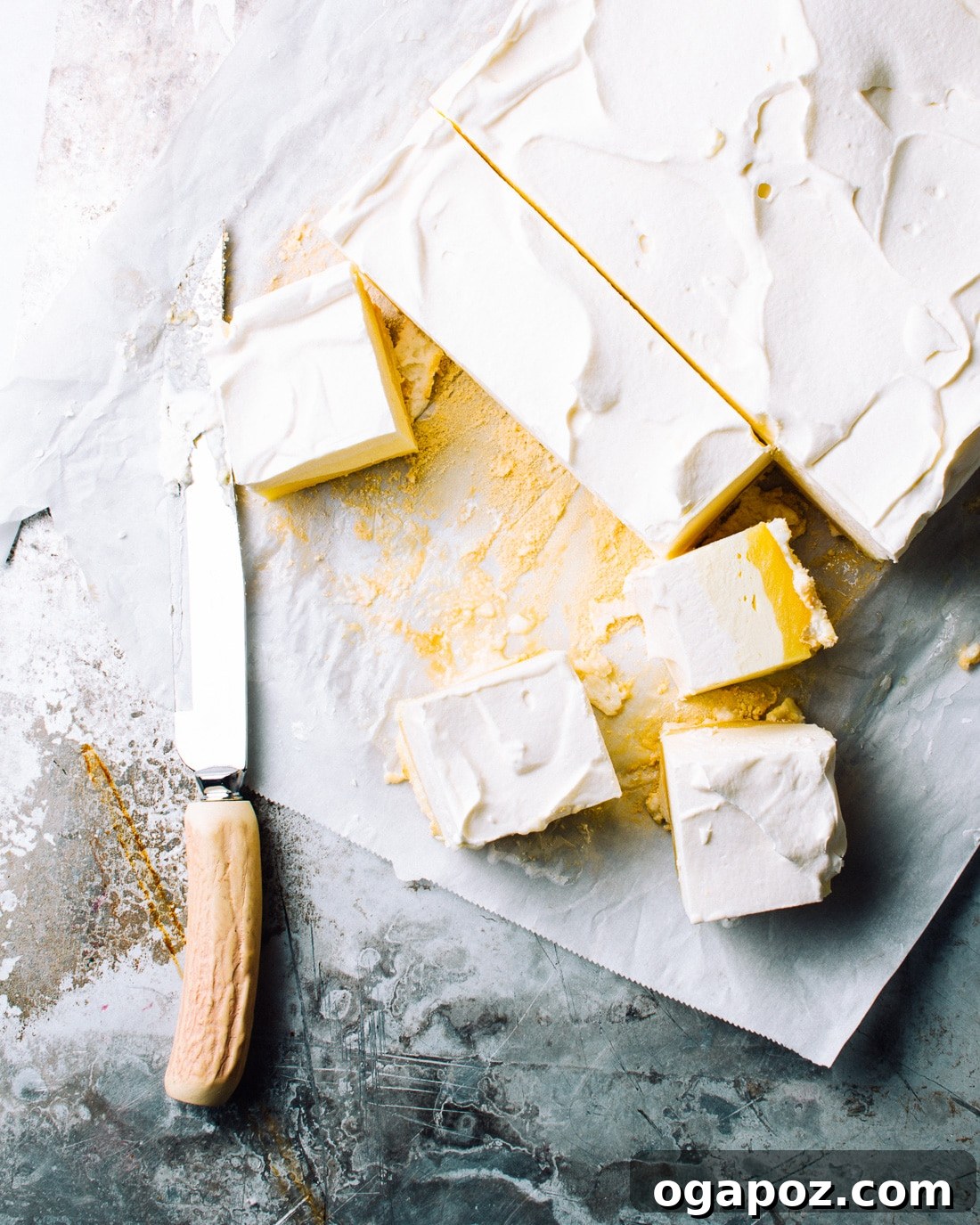 Sunshine Lemon Silk Bars 3 Lemon Mousse Bars displaying their distinct layers: meringue, lemon curd, lemon mousse, and whipped cream.