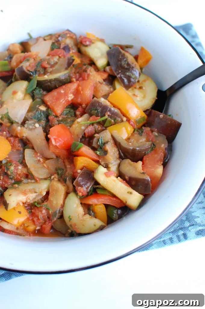 The Ultimate Ratatouille: Fresh, Flavorful, French 3 Ratatouille Recipe served with a spoon in a white bowl