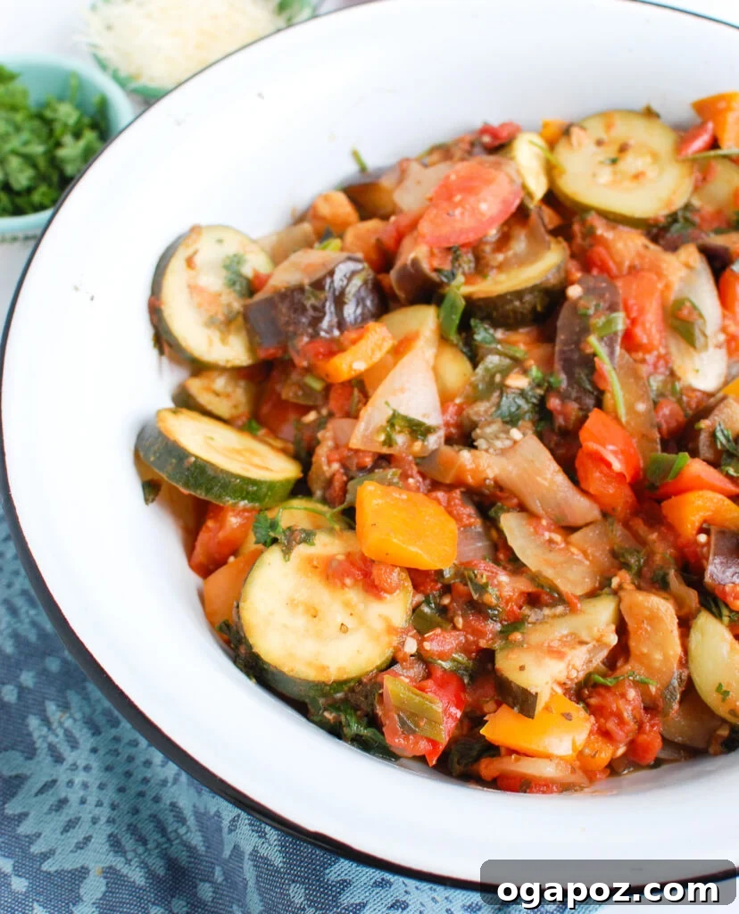 The Ultimate Ratatouille: Fresh, Flavorful, French 4 Side view of Ratatouille Recipe in a white bowl with rustic bread