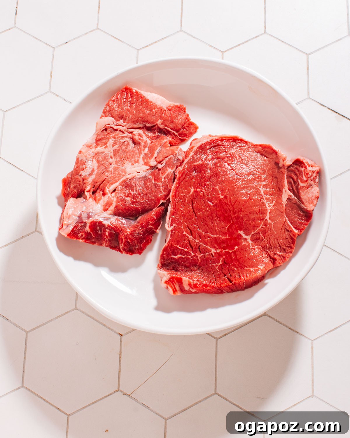 Perfectly Grilled Flat Iron Steak with Creamy Peruvian Aji Verde 3 Seasoned flat iron steaks on a plate, ready for grilling.