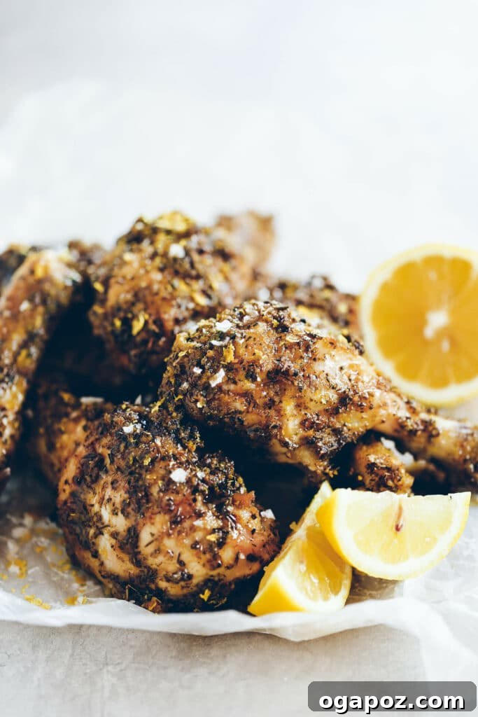 41 Delicious Chicken Drumstick Recipes: Simple and Super Juicy 11 Crispy Baked Italian Drumsticks stacked on a parchment paper