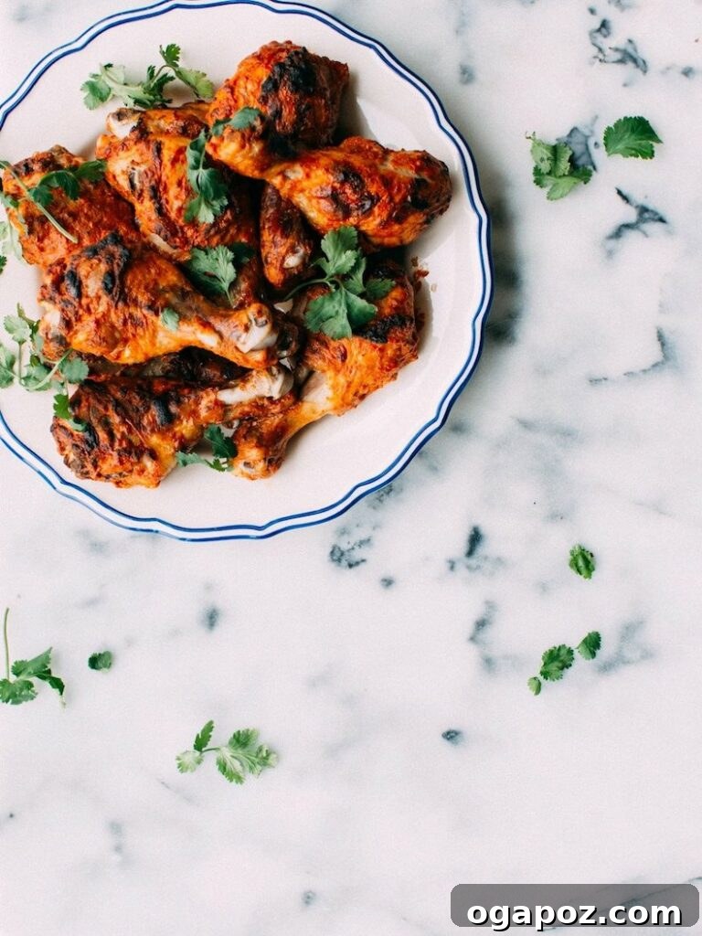 41 Delicious Chicken Drumstick Recipes: Simple and Super Juicy 3 Tandoori chicken drumsticks on a white plate