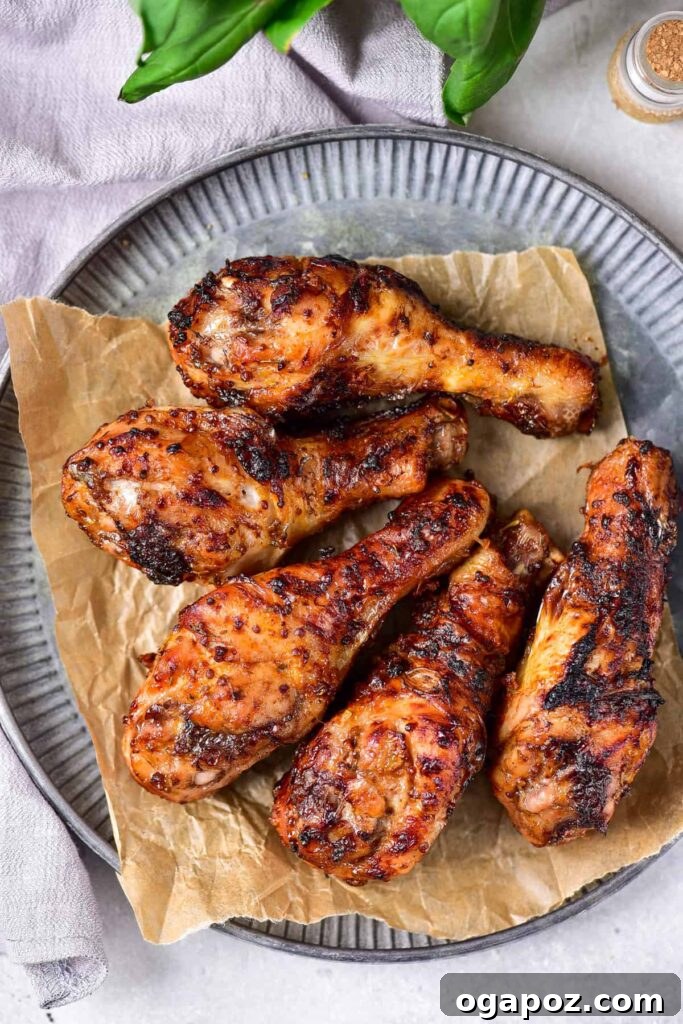 41 Delicious Chicken Drumstick Recipes: Simple and Super Juicy 25 Maple Mustard Chicken Legs served on a grey plate
