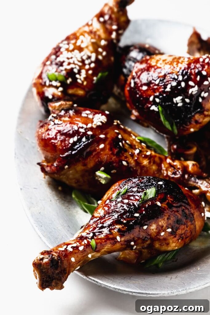 41 Delicious Chicken Drumstick Recipes: Simple and Super Juicy 9 Sesame Soy Chicken Drumsticks stacked on a small plate