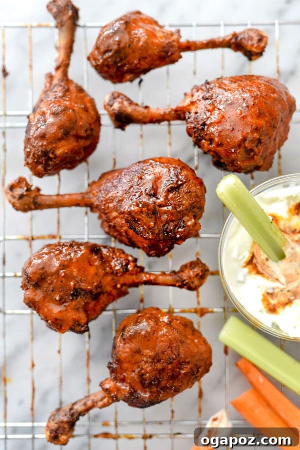 41 Delicious Chicken Drumstick Recipes: Simple and Super Juicy 10 Buffalo Chicken Drumsticks on a wire rack with a dip