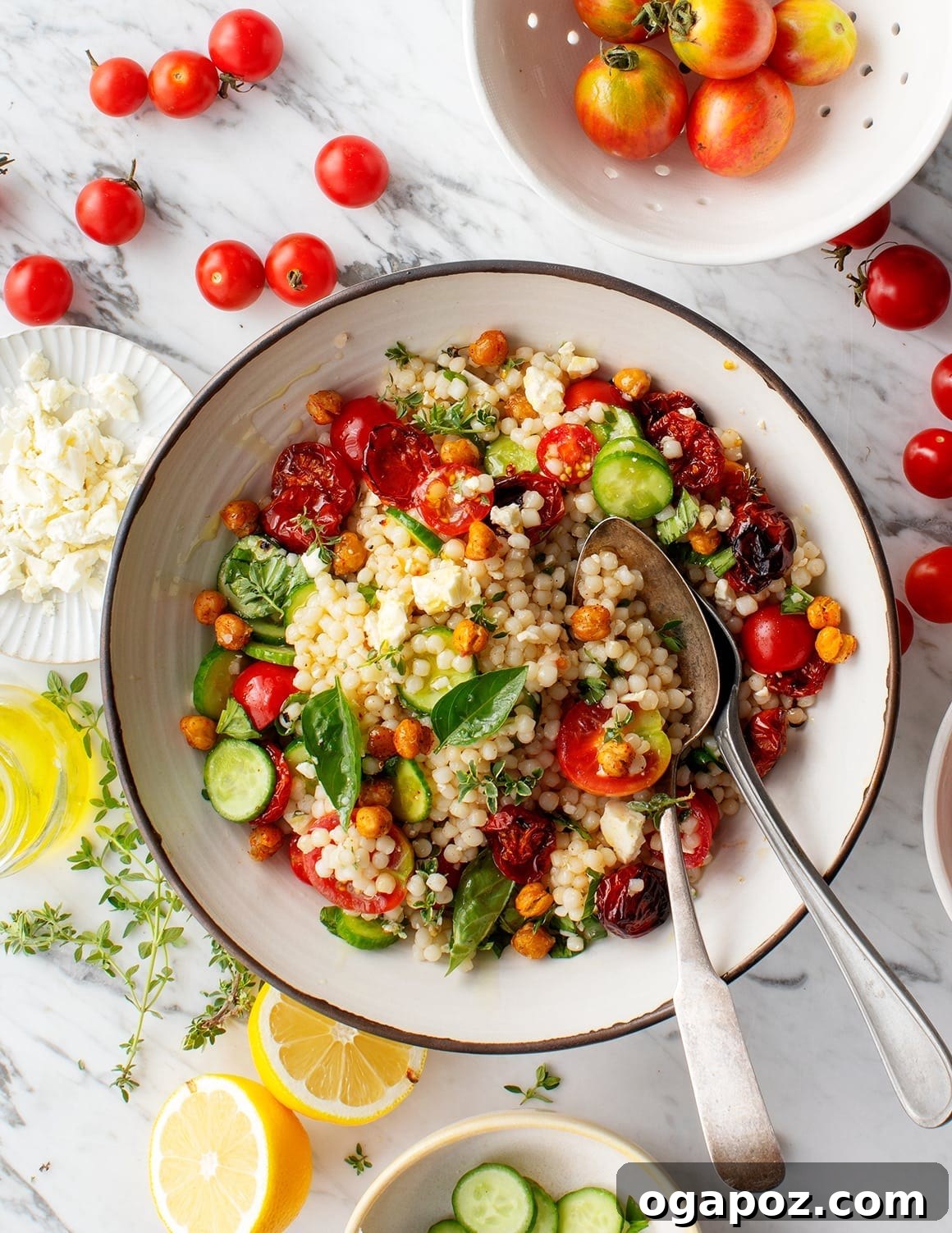 9+ Phenomenal Israeli Couscous Recipes You Must Try 5 Fresh Israeli couscous salad, vibrant with roasted cherry tomatoes and fragrant basil, served beautifully on a plate.