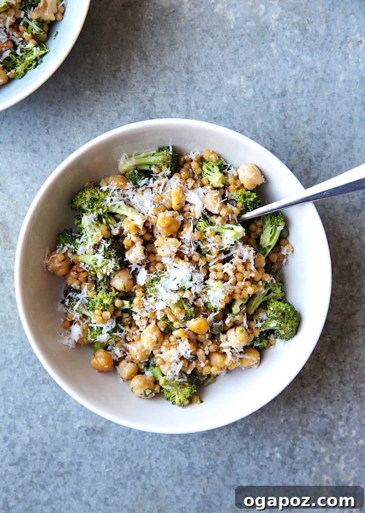 9+ Phenomenal Israeli Couscous Recipes You Must Try 7 A hearty Israeli couscous salad featuring roasted broccoli, savory chickpeas, and a vibrant pesto dressing, served on a plate.