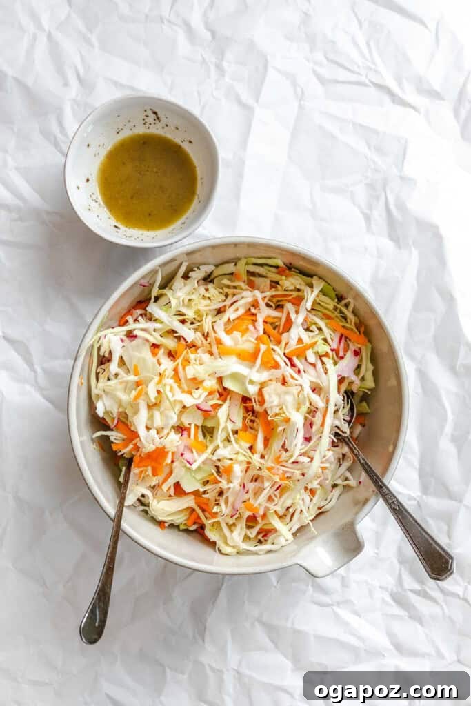 Bright & Tangy Mayo-Free Coleslaw 12 Dressing being poured into Healthy Coleslaw