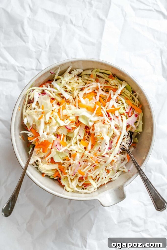 Bright & Tangy Mayo-Free Coleslaw 9 Prepared Healthy Coleslaw vegetables in a mixing bowl