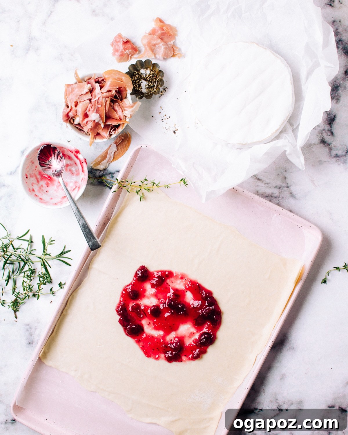 Gourmet Brie & Prosciutto Puff Pastry with Cranberries 4 Spreading cranberry sauce on puff pastry for baked brie