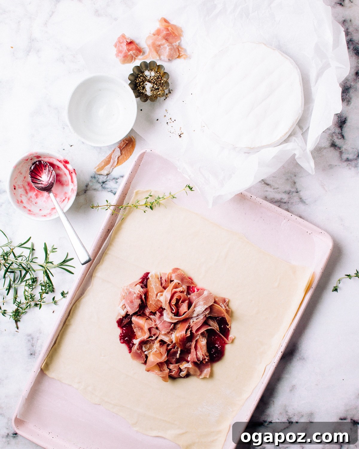 Gourmet Brie & Prosciutto Puff Pastry with Cranberries 5 Layering torn Prosciutto di Parma over cranberry sauce