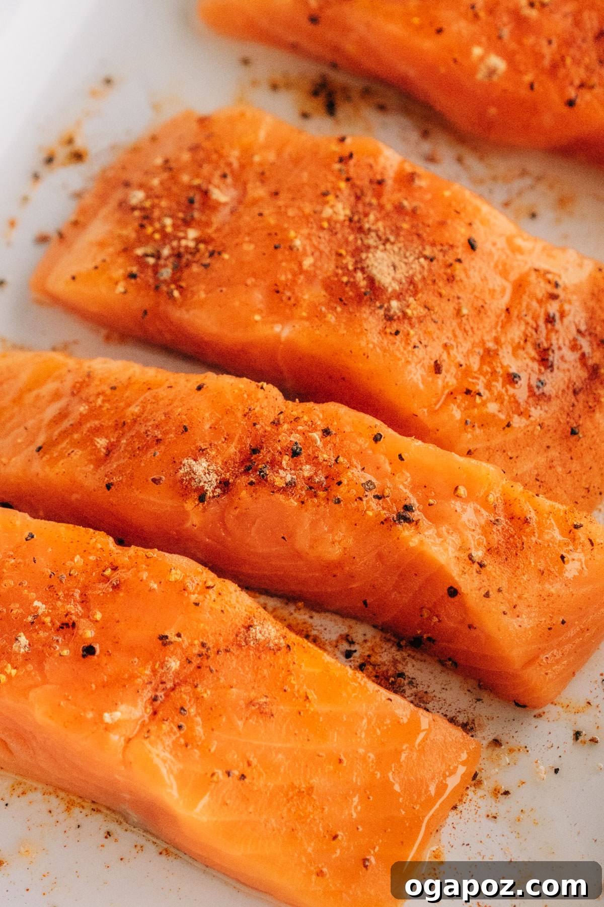 Melt-in-Your-Mouth Grilled Salmon 5 Raw salmon seasoned on a plate.