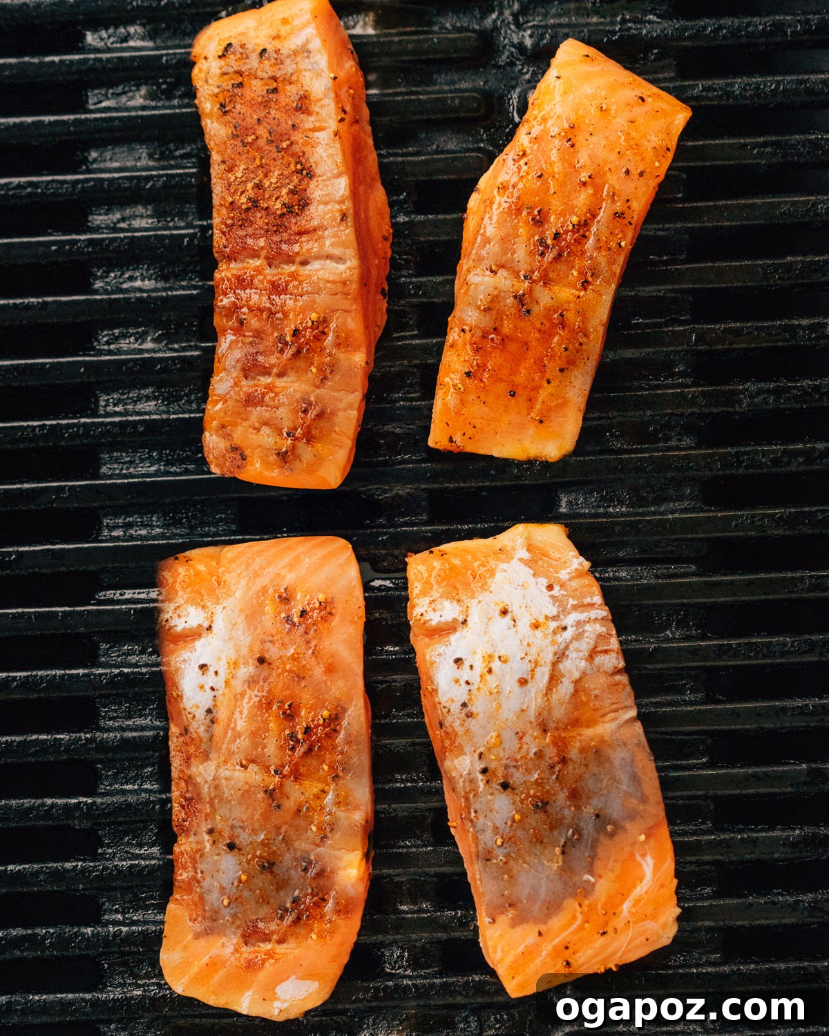 Melt-in-Your-Mouth Grilled Salmon 6 Pieces of salmon on grill grates.