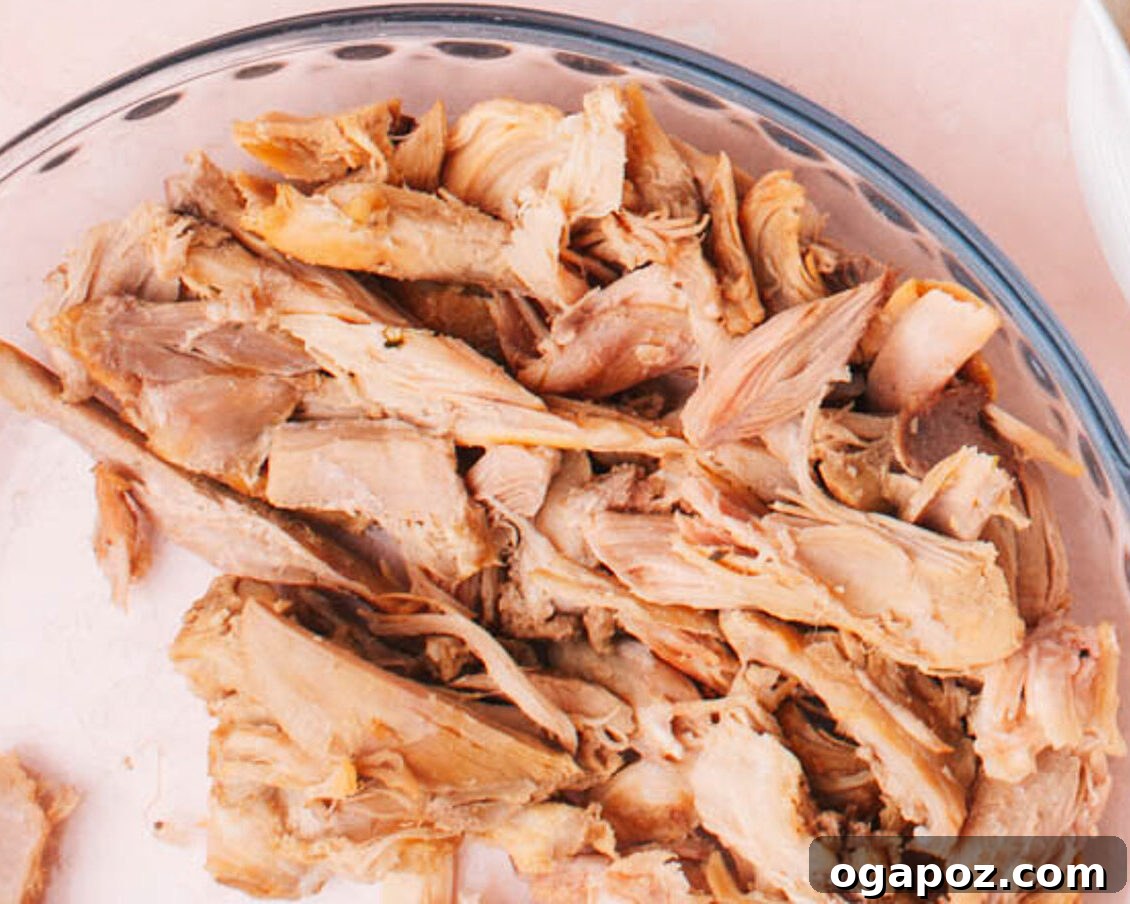 Set and Forget Slow Cooker Whole Chicken 3 Shredded slow cooker chicken ready for various meals.