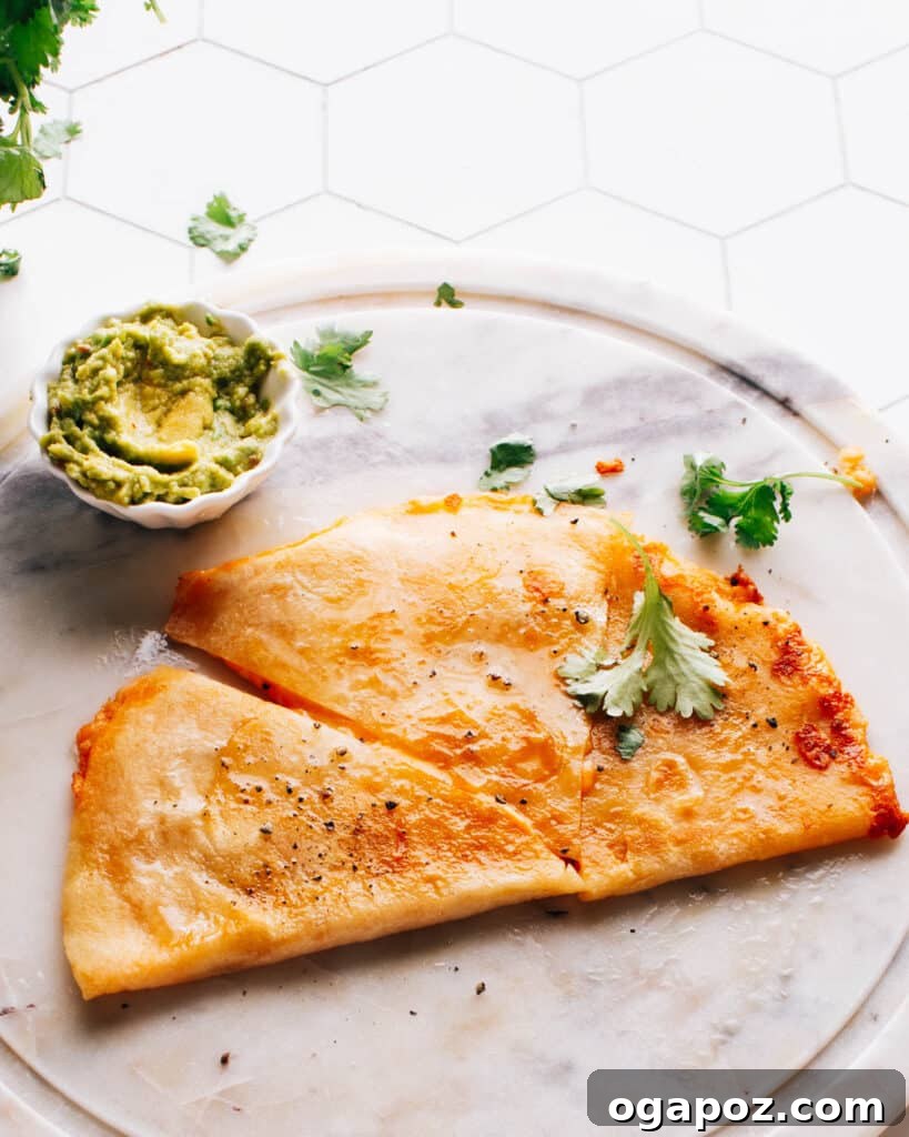 Ultimate Game Day Grub 17 Cheese quesadill aon a plate with guacamole.