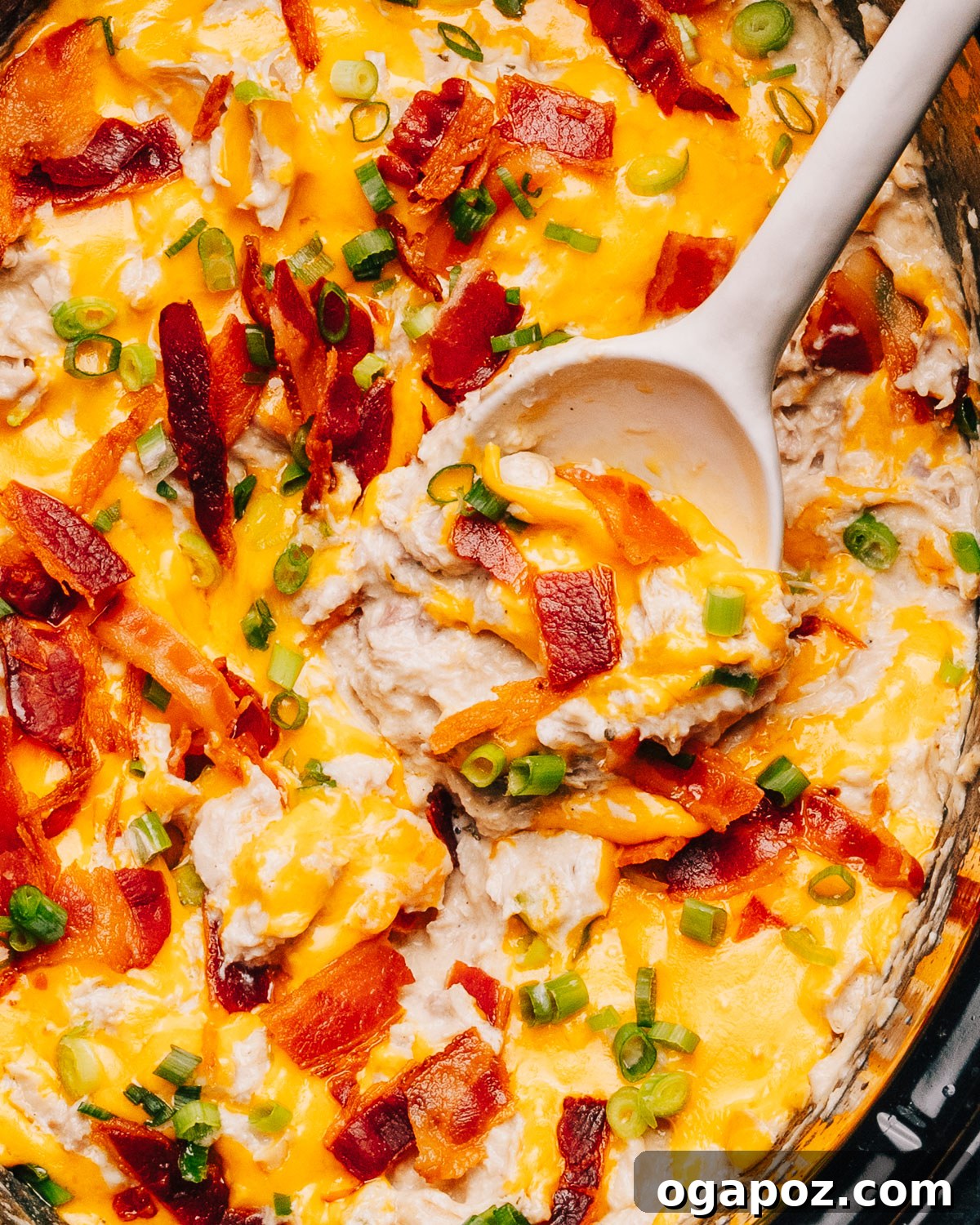 Ultimate Game Day Grub 19 Crack Chicken in slow cooker with a spoon.