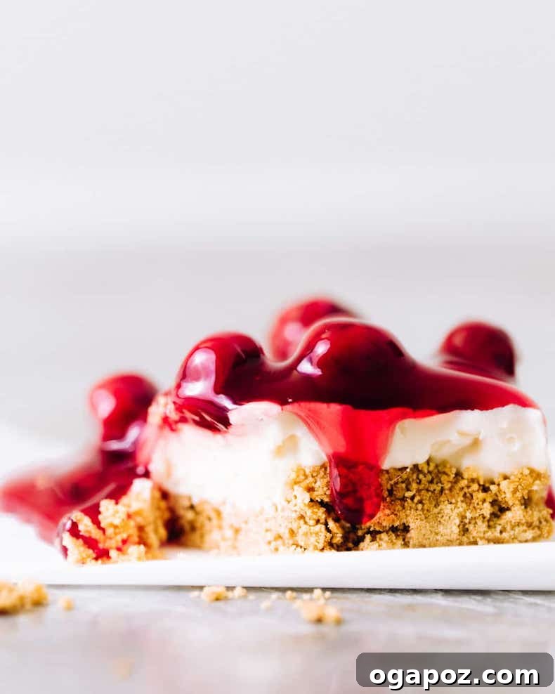 No-bake cherry cheesecake bars with graham crust and cherry topping.