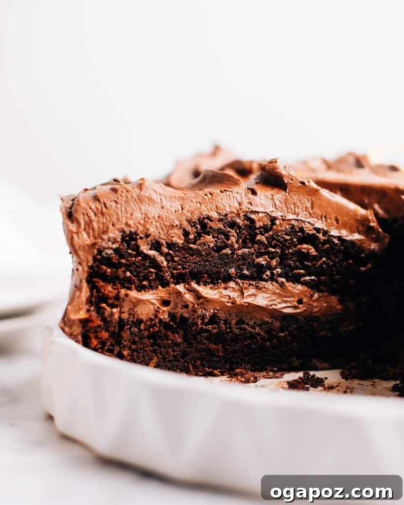 Frosted moist chocolate cake with a slice removed so you can see inside.