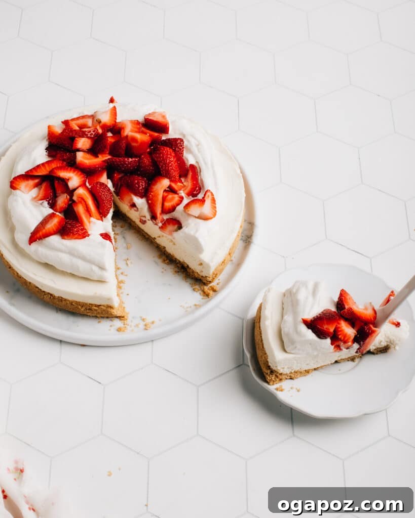 No-bake cheesecake topped with strawberries on a plate.