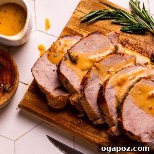 Pork gravy drizzled over roast pork loin.